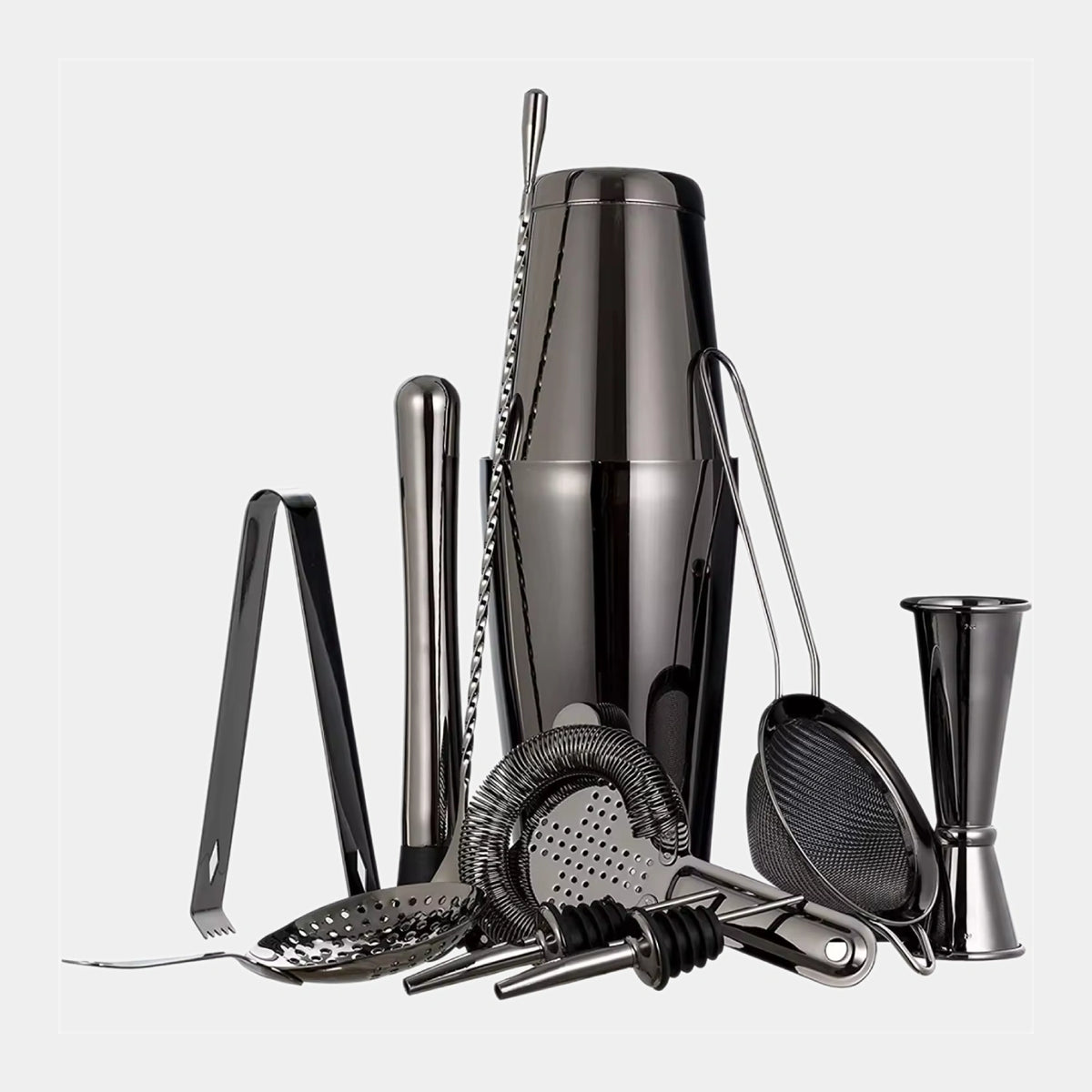 A professional bar tool set in polished black stainless steel, including a cocktail shaker, jigger, strainer, muddler, ice tongs, and bar spoons, arranged on a light gray background.