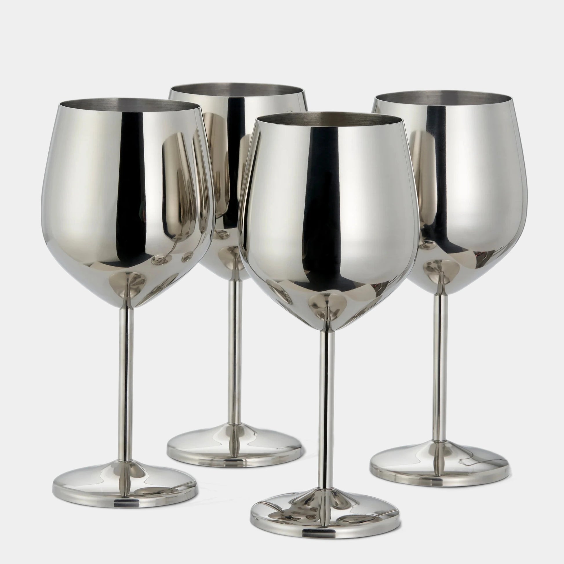 Four polished silver wine glasses arranged together on a light gray background.