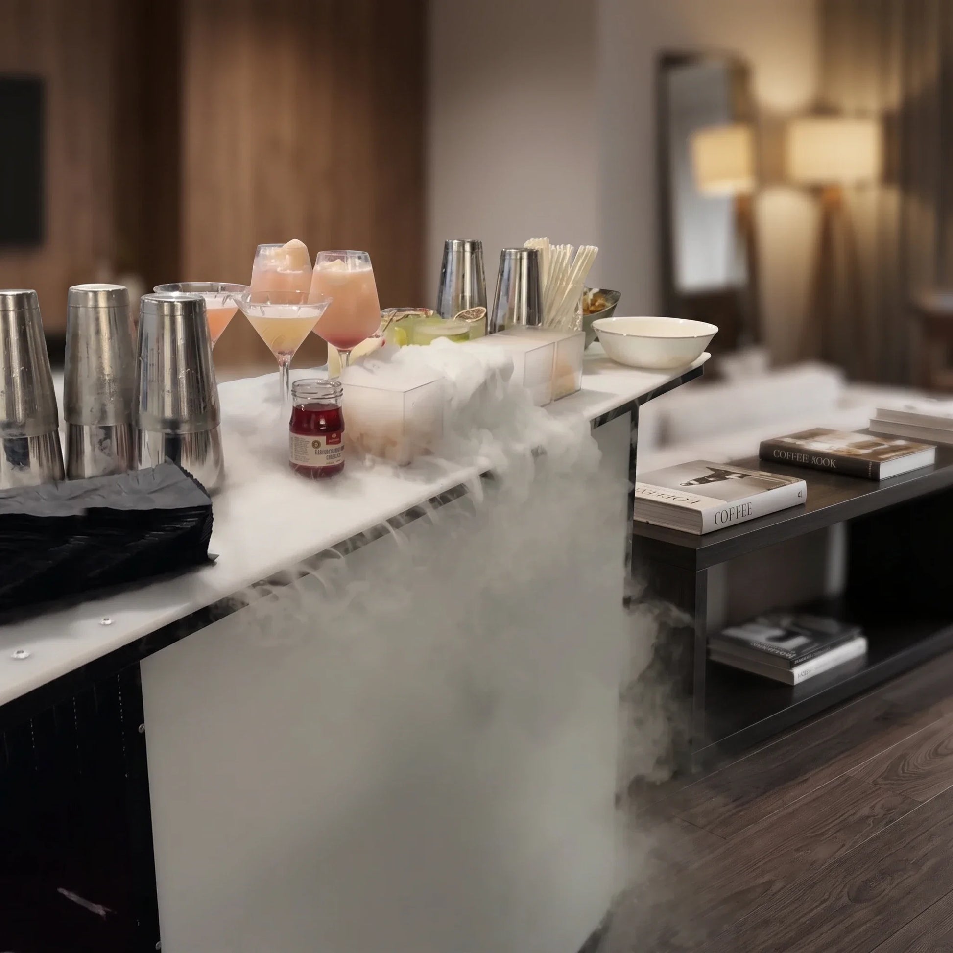 Premium Mobile Bar in a dimly lit room with cocktail shakers, pink cocktails and dry-ice smoke on the countertop.