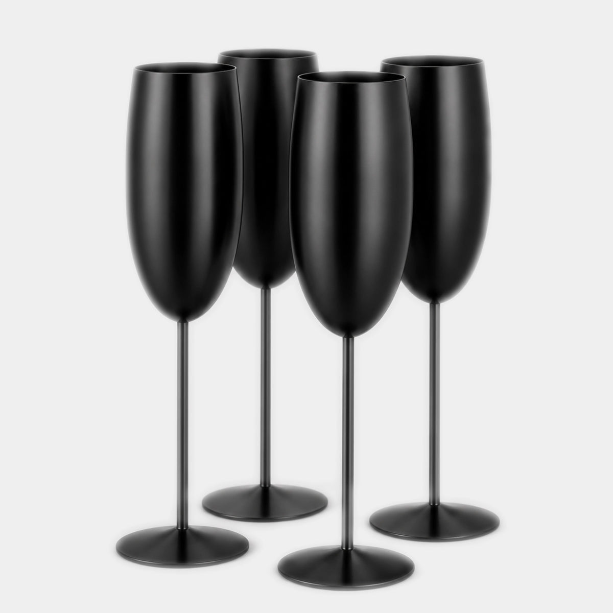 Four matte black champagne flutes arranged together on a light gray background.