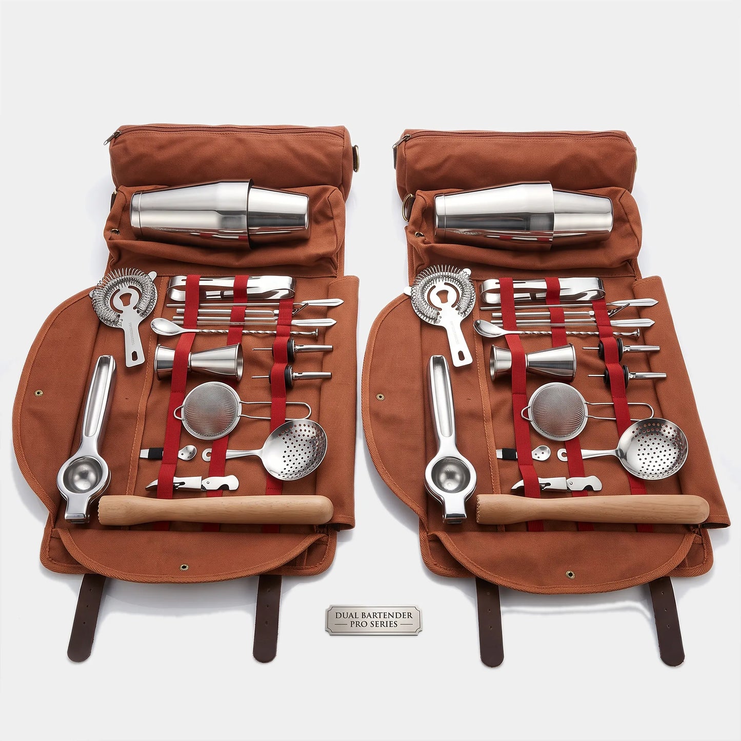 Two matching brown canvas roll-up tool cases opened side by side, each holding a stainless steel cocktail bartender set with wooden-handled tools, strainers, muddler, ice bucket, and metal cups. A small plaque at the bottom reads 'COCKTAIL BARTENDER SET V.