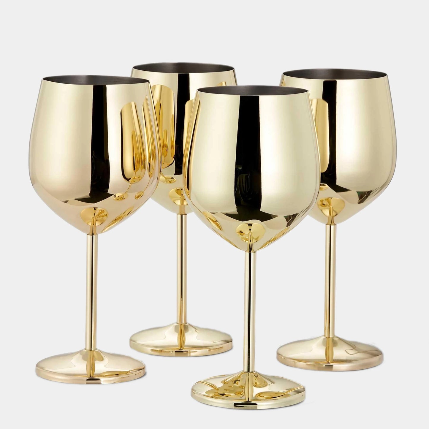 Four shiny gold wine glasses arranged together on a light gray background.