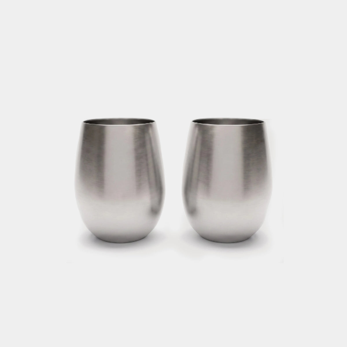 Two brushed stainless steel stemless wine glasses on a light gray background.