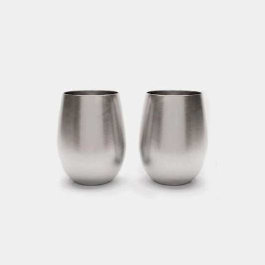 Two brushed stainless steel stemless wine glasses on a light gray background.