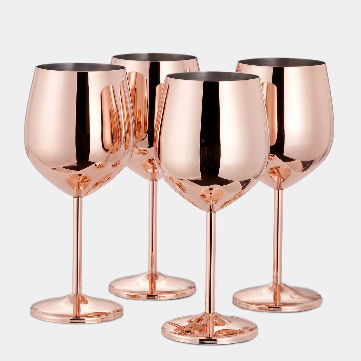 Four metallic rose gold wine glasses arranged in a group against a light gray background.